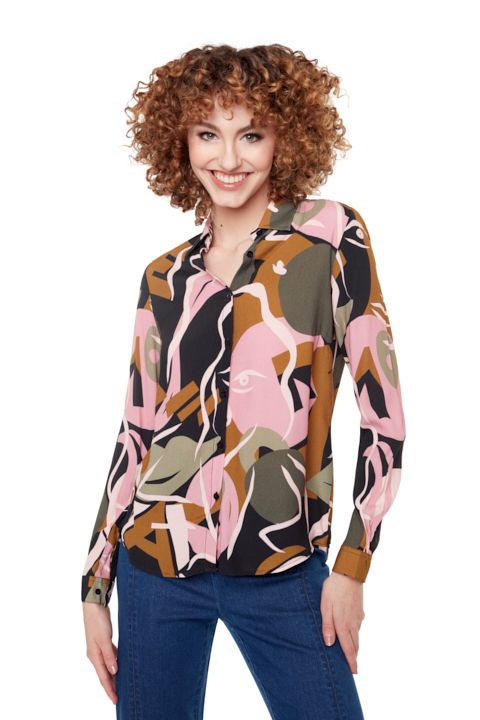 A woman wearing a pink and black blouse.