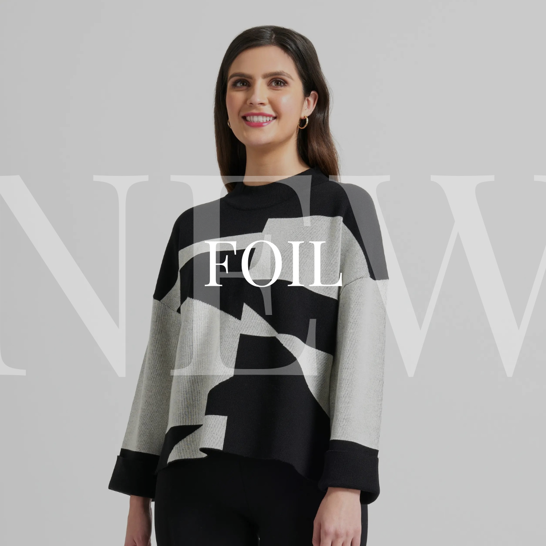 A woman wearing a black and grey sweater with the words'foil'.