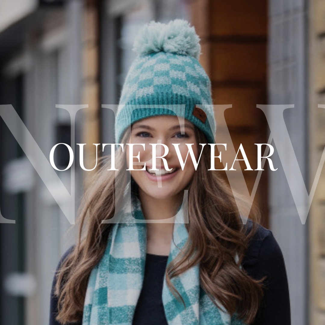 A young woman wearing a hat and scarf with the words new outerwear.