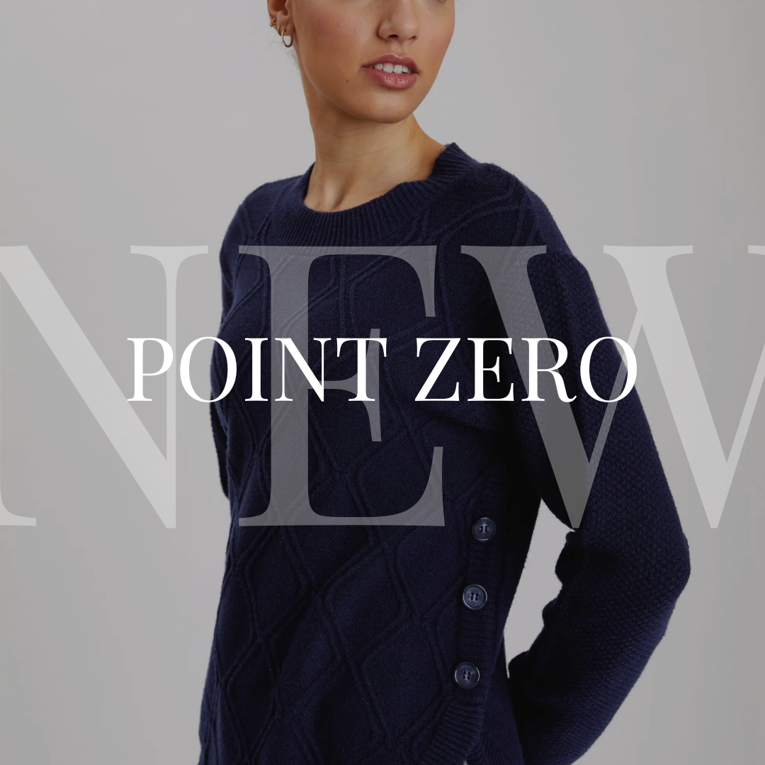 A woman is posing in a blue sweater with the words point zero.