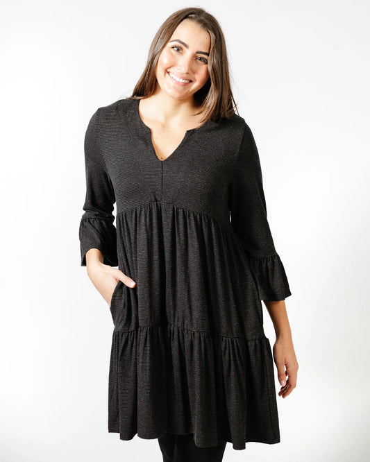A versatile woman wearing the Shannon Passero Devan Dress made from eco-friendly fabric.