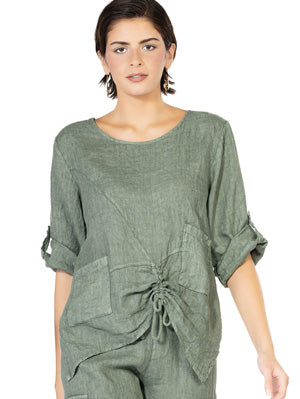 A woman wearing a high-quality Cherishh Linen Top with front Pocket and Cuffs in green.