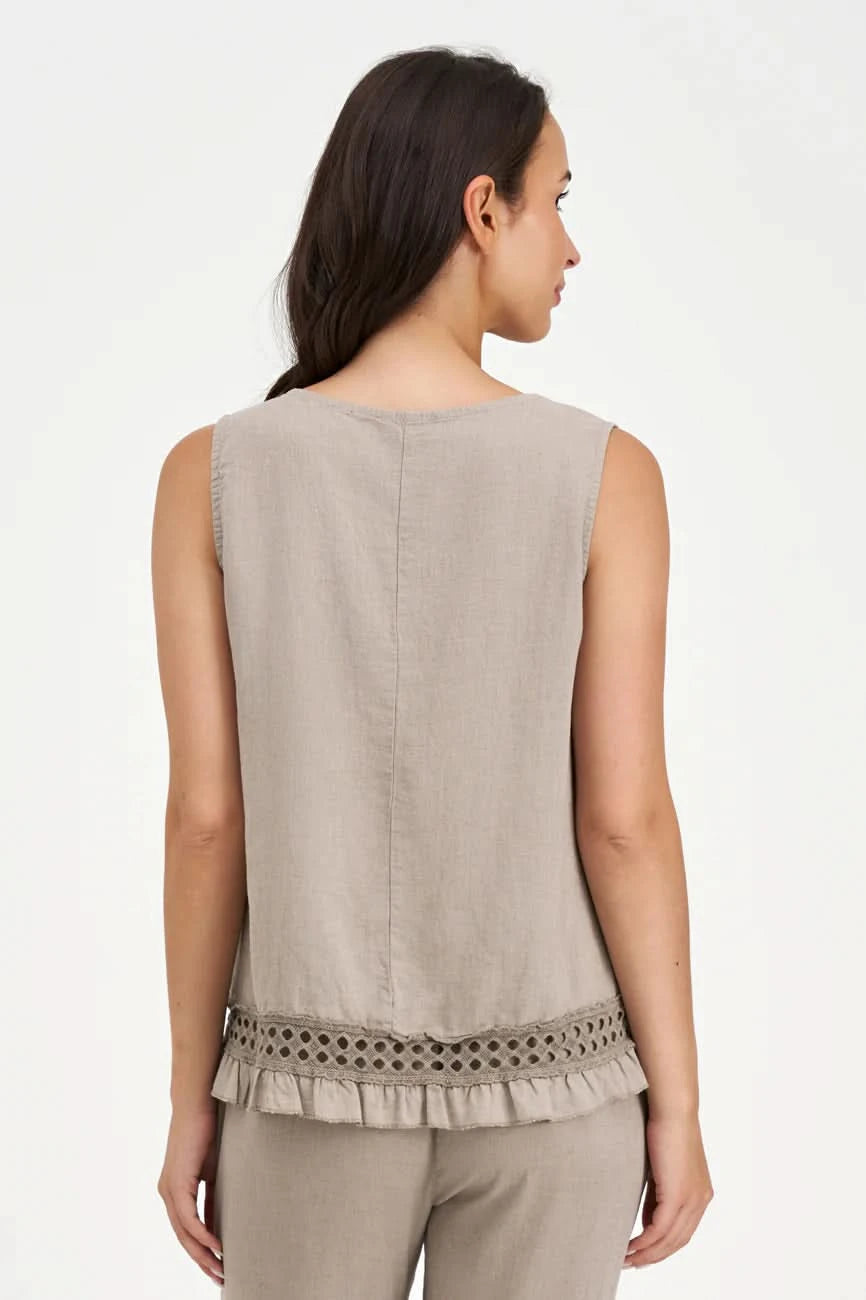 A woman wears the M Made In Italy Boho Top, a sleeveless beige piece with lace trim and ruffle hem, paired with matching pants, standing against a white background.