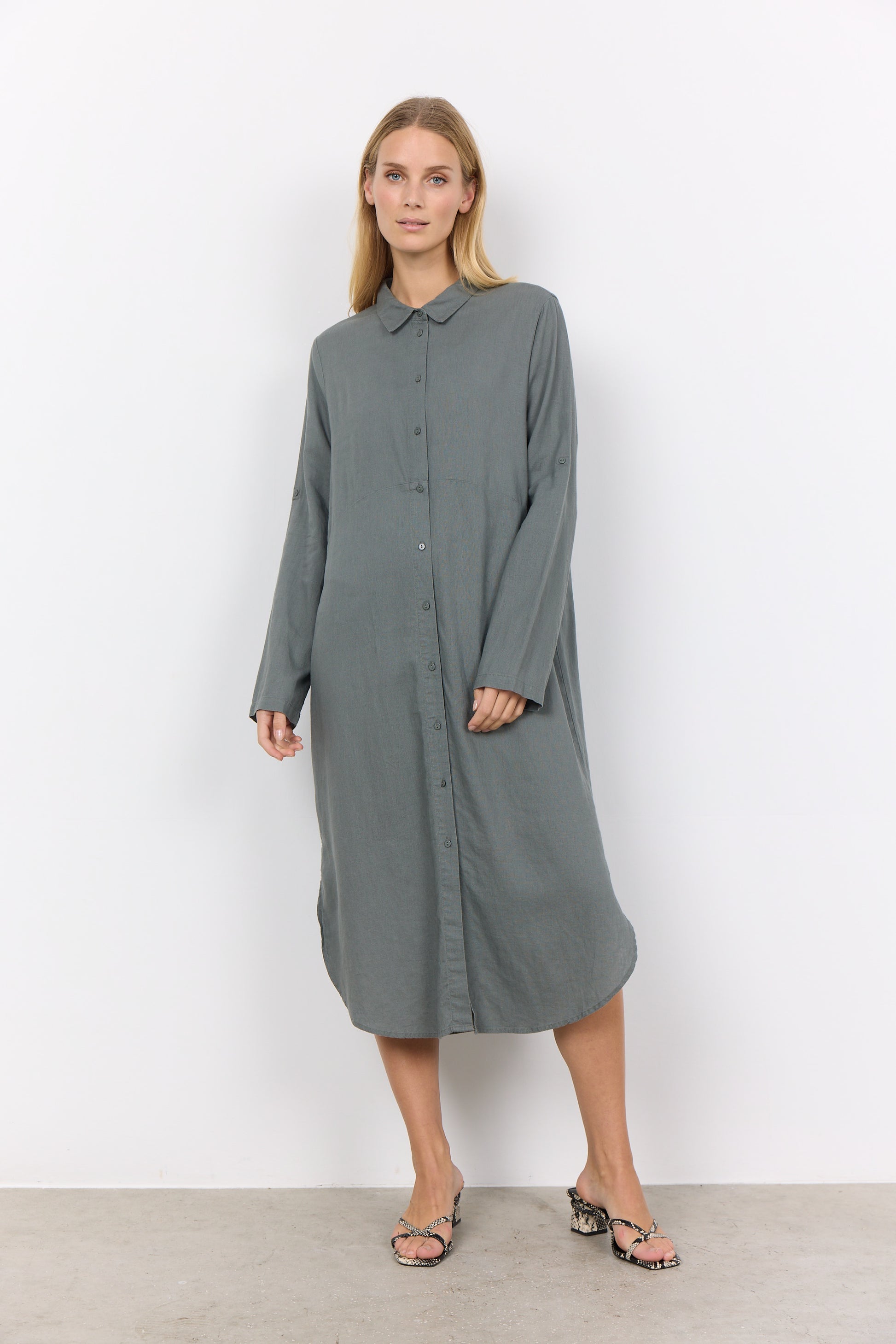 A woman in a Soya Concepts Button Up Long Sleeve Dress.