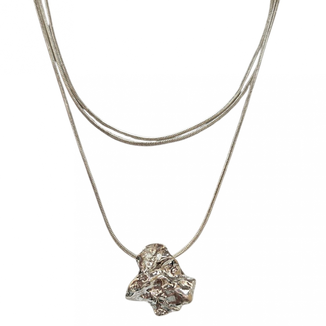 The Merx Textured Metal Short Necklace pairs with a longer chain featuring an abstract, textured pendant, offering a striking and modern silver-toned layered look.