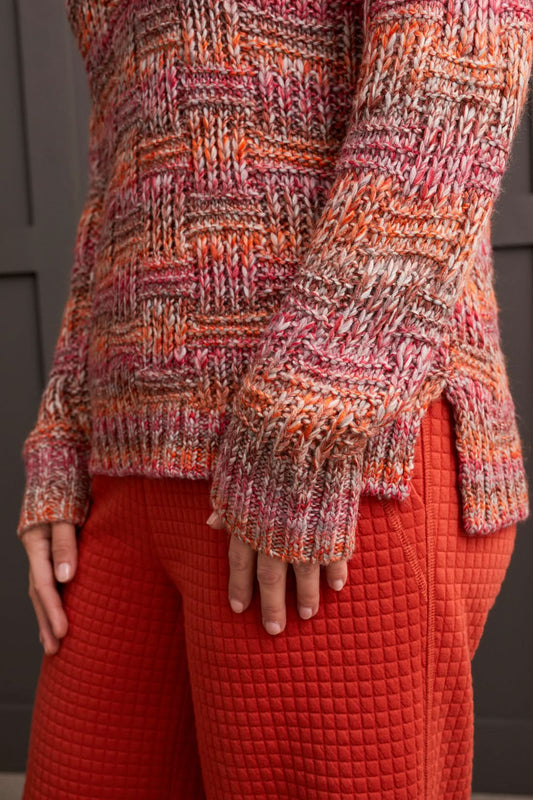 A person wearing a multicolored, fashionable long sleeve cowl neck sweater by Tribal with a textured pattern.