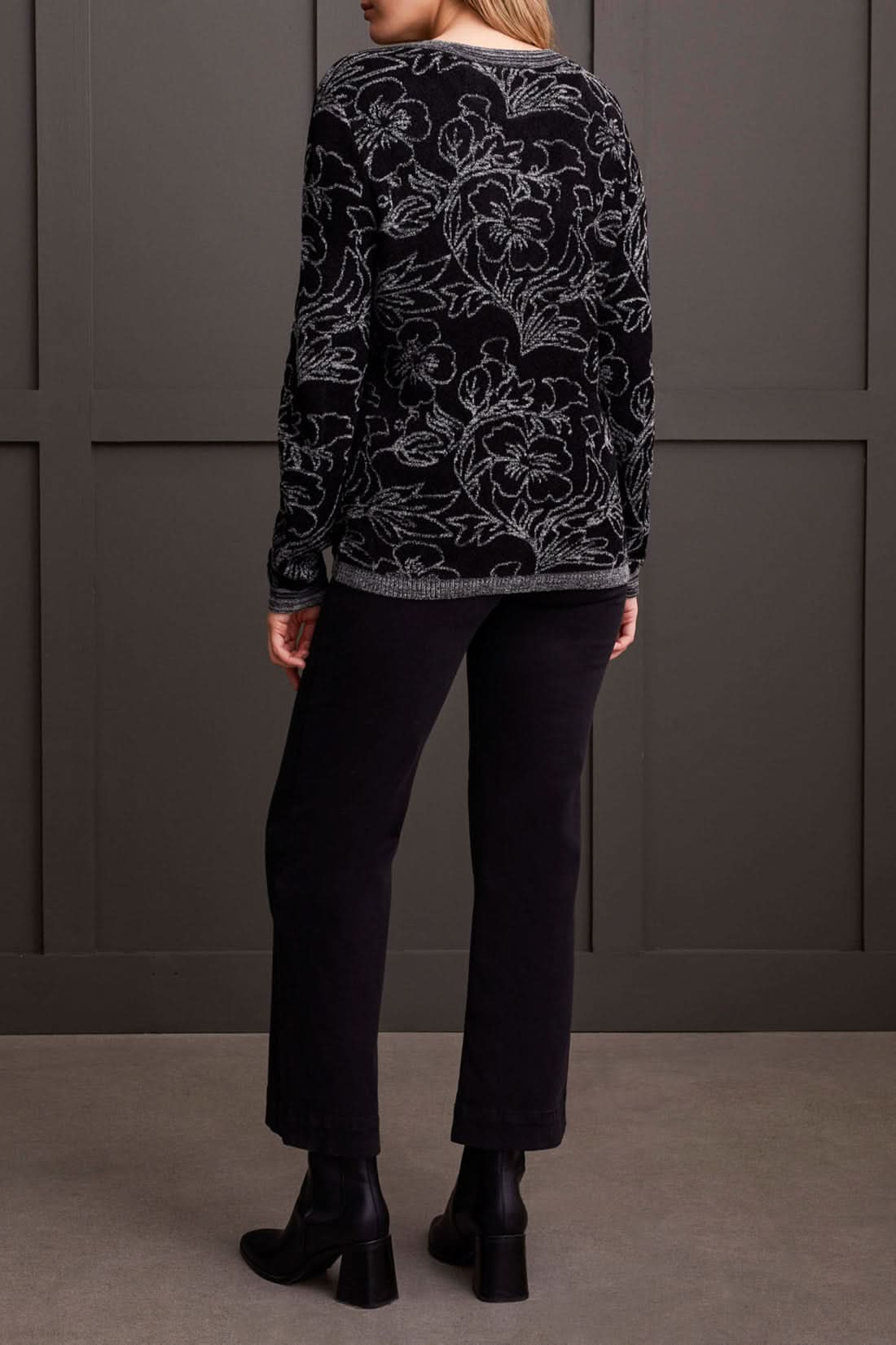 Close-up of a person wearing a cozy, stylish Long Sleeve Scoop Neck Sweater by Tribal, featuring intricate grey floral patterns. The person's head is partially visible, showcasing this perfect piece for fall fashion.