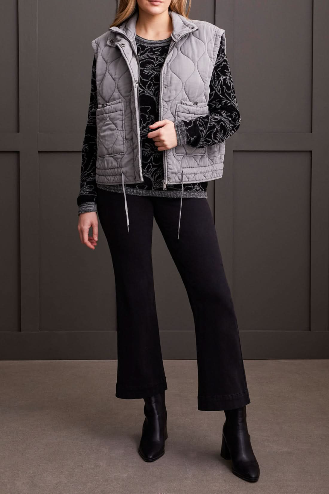 Close-up of a person wearing a cozy, stylish Long Sleeve Scoop Neck Sweater by Tribal, featuring intricate grey floral patterns. The person's head is partially visible, showcasing this perfect piece for fall fashion.