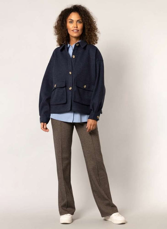 The woman is wearing a Yest Dark Navy Shacket with buttons.