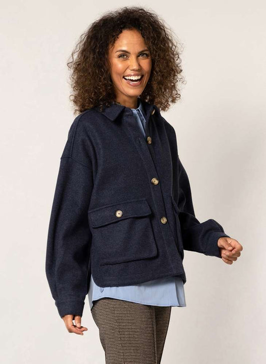 The woman is wearing a Yest Dark Navy Shacket with buttons.