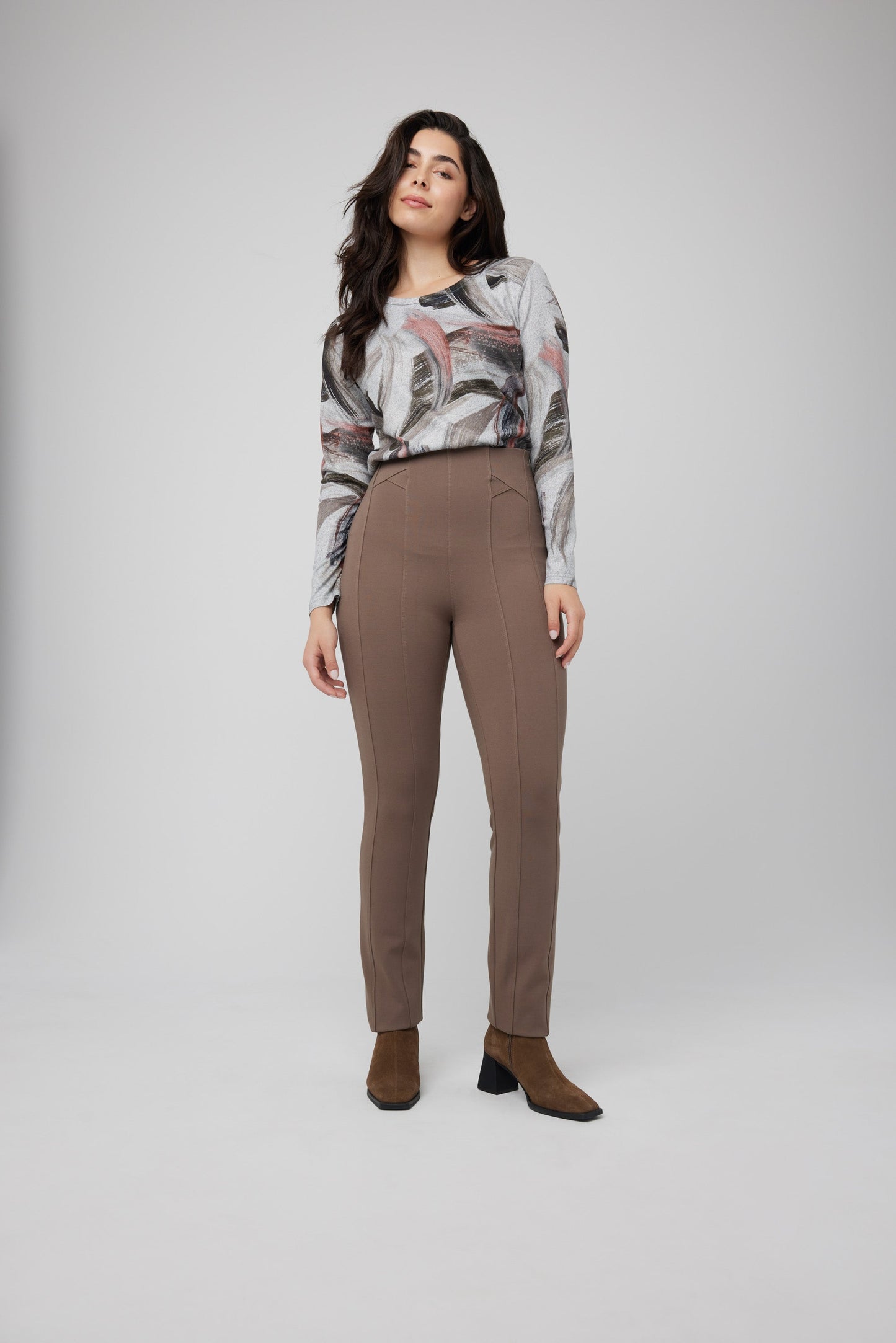 The model is wearing a slimming fit beige sweater and Coco Y Club's Front Seam Slim Pull On Pant in brown, perfect for everyday wear.