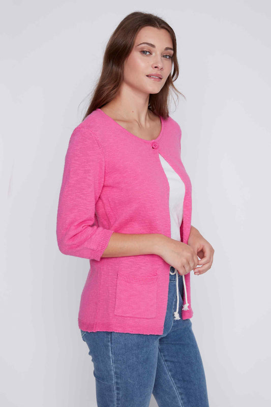 A cozy woman in a pink CoCo Y Club Round Neck Button Up Cardigan and jeans.