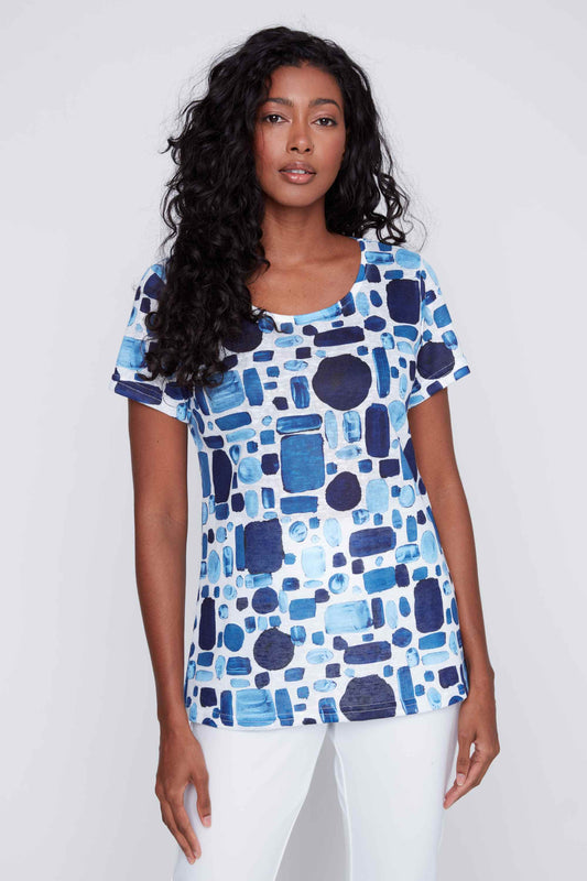 A woman wearing a versatile blue and white Round Neck Gem Short Sleeve Top from CoCo Y Club.