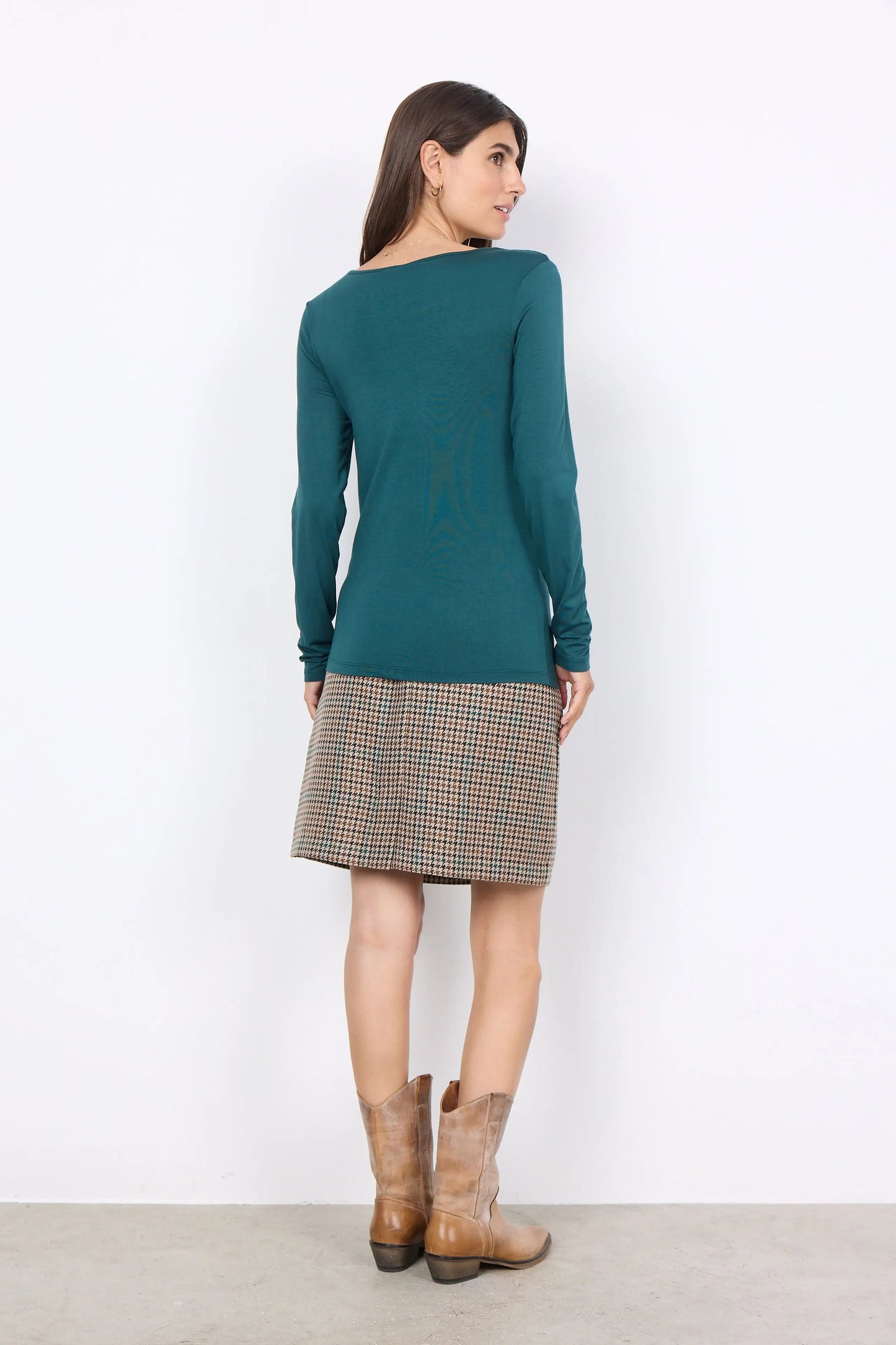The model is wearing a soft quality Marcia 217 Rounded Neck Blouse with a checkered skirt. (Brand Name: Soya Concepts)