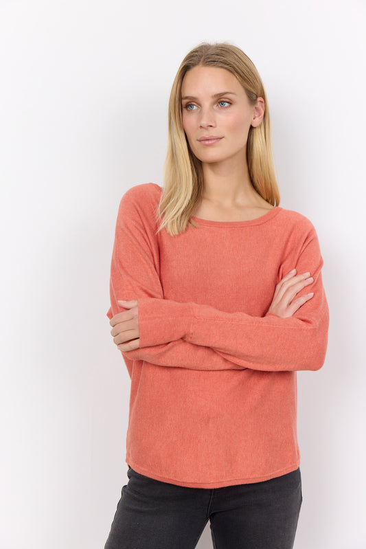 The model is wearing a coral Soya Concepts Dollie 620 Long Sleeve Sweater and black jeans.