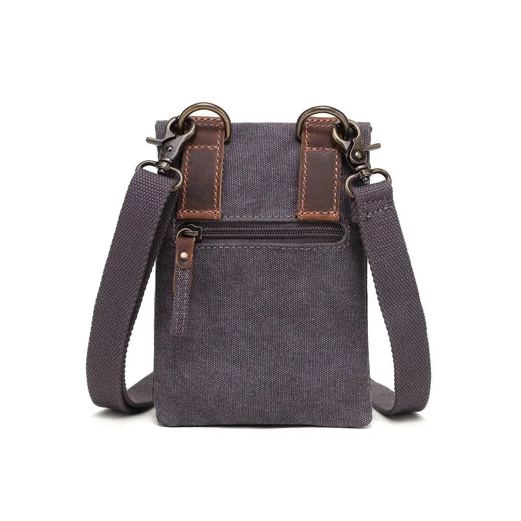 A Davan Canvas Shoulder Bag with Leather Stripe Card Locker and an adjustable shoulder strap.