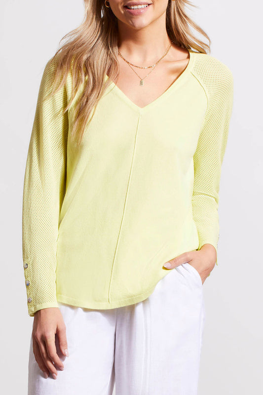 Woman wearing a yellow Tribal 3/4 Sleeve Raglan Sweater with a V-Neck and white pants.