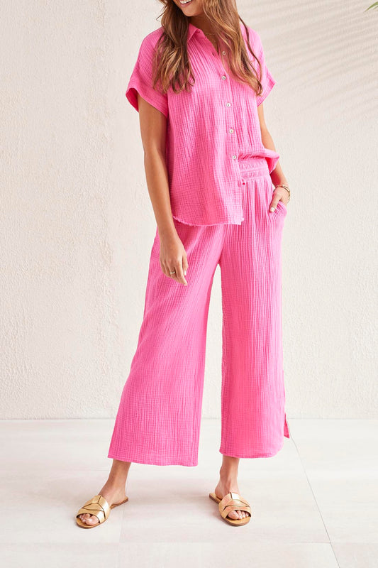 A woman wearing Tribal's Wear 2 Ways Wide Leg Pant with a Slit and a pink shirt.