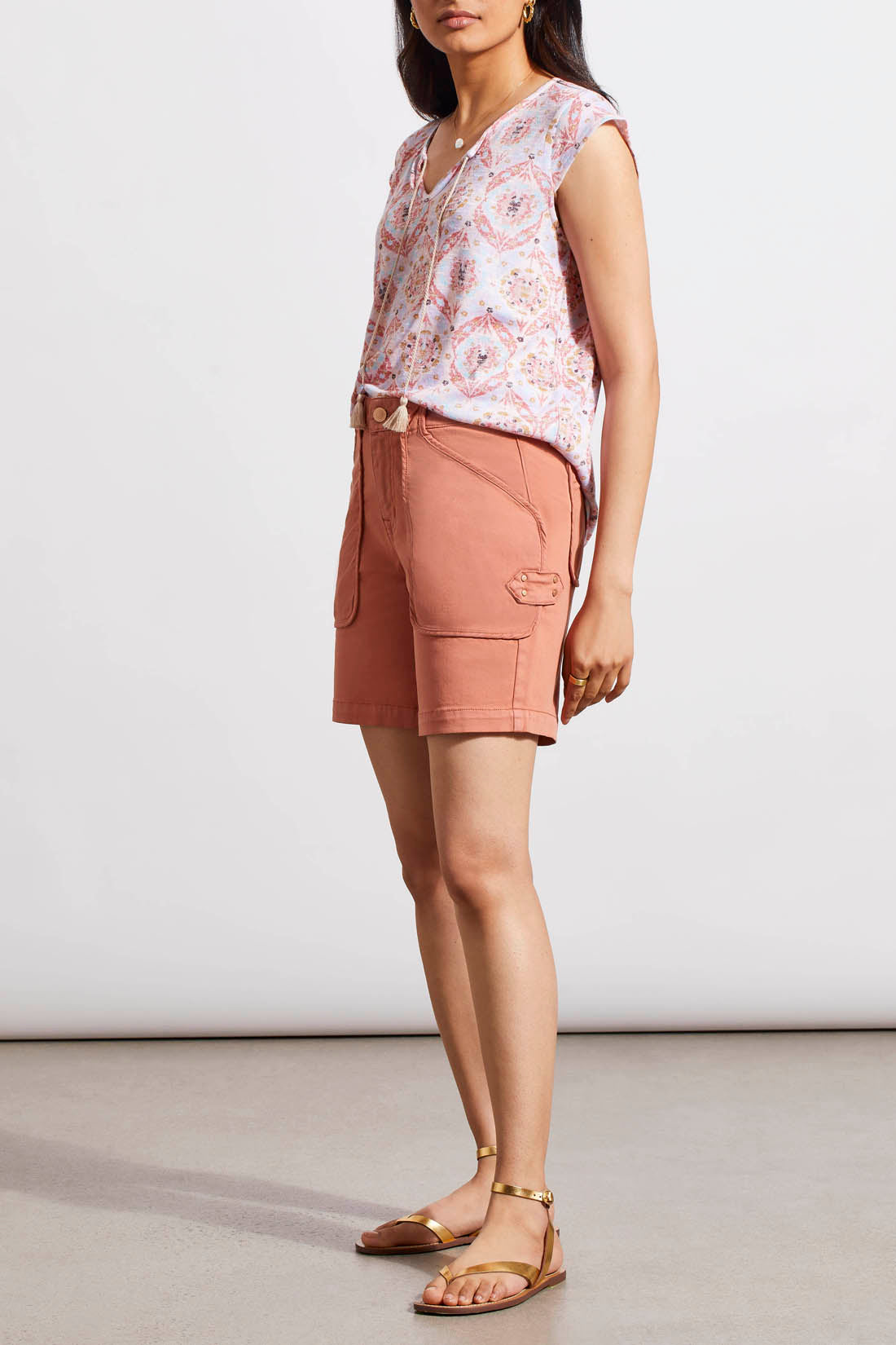 A woman in Dark Cyder Patch Pocket Girlfriend Shorts by Tribal is standing in front of a white wall.