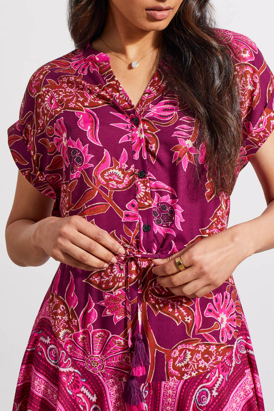 Woman in a patterned pink Tribal Combo Print Dress with waist drawcord detail.