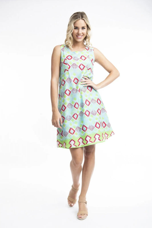 A woman smiling while posing in a Zio Turq Dress Reversible Sleeveless by Orientique on a white background.