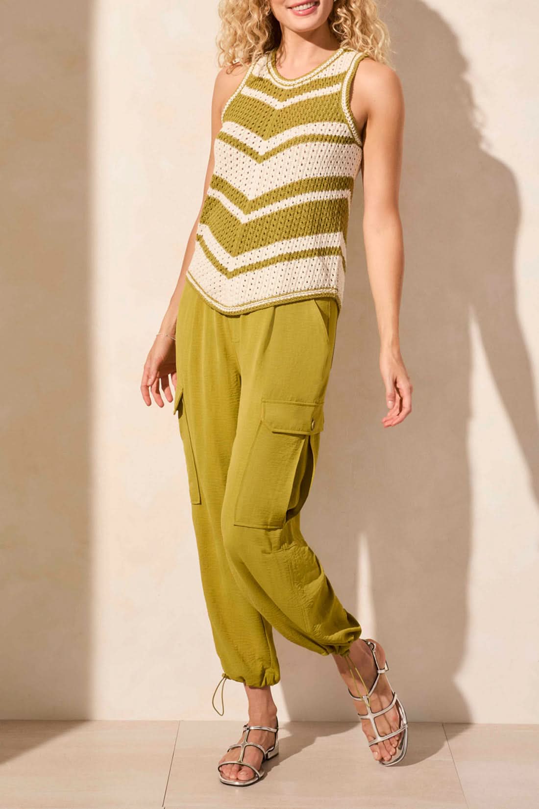 Sporting an effortless style with the CREW NECK RACER BACK SWEATER, a sleeveless knit top in green and white stripes by Tribal, paired with green pants.