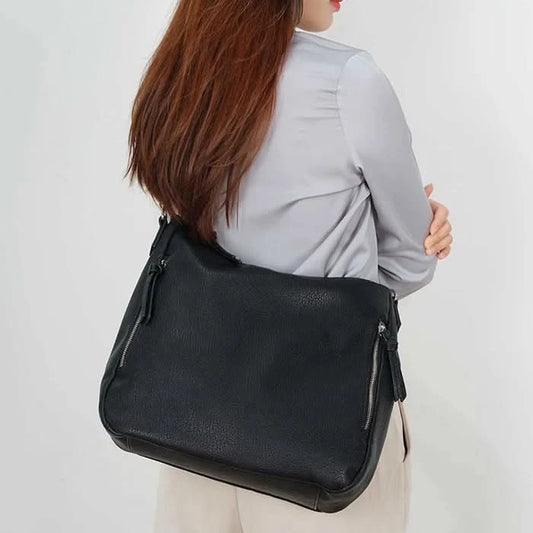 The Megan Hobo Shoulder Bag by Co-Lab features green leather, a beige interior with an inner pocket and zipper, and a partial view of the Co-Lab brand name printed inside.