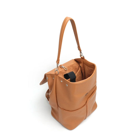 A Co-Lab Bellarose Shoulder Bag or Backpack in tan recycled vegan leather, with a single strap, front pocket, and flap closure, is shown against a plain white background.