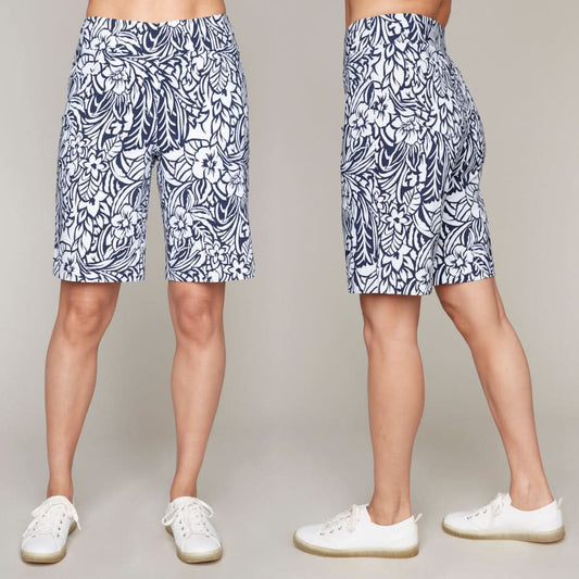 Front and side profiles of a model wearing Carre Noir's Blue Floral Print Bermuda Shorts and white sneakers, set against a gray background.