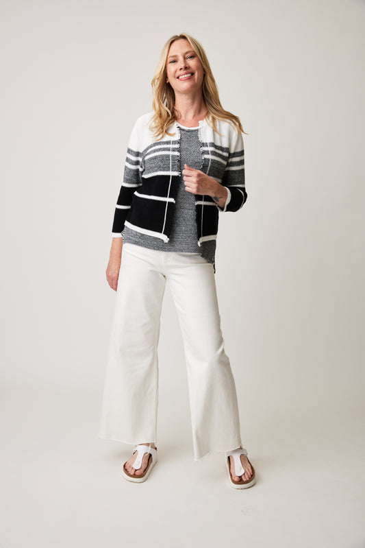 Woman posing in a stylish, Color Country Juliana Cardi cardigan and white pants against a neutral background.