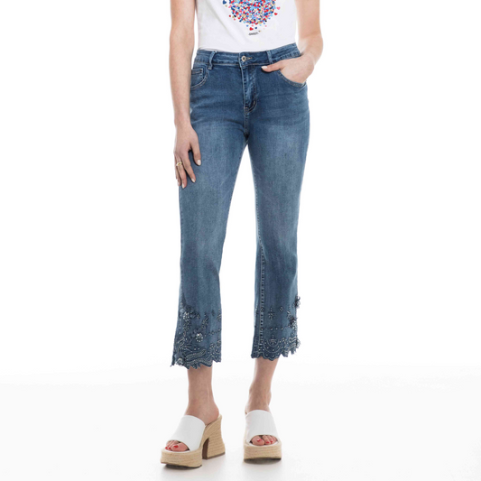 Woman wearing Orly's Flower Detailed Hem Jeans with floral detailing and white platform sandals.