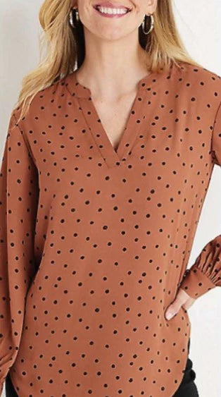 A woman wearing a Motion Dotted Print Copper Blouse.