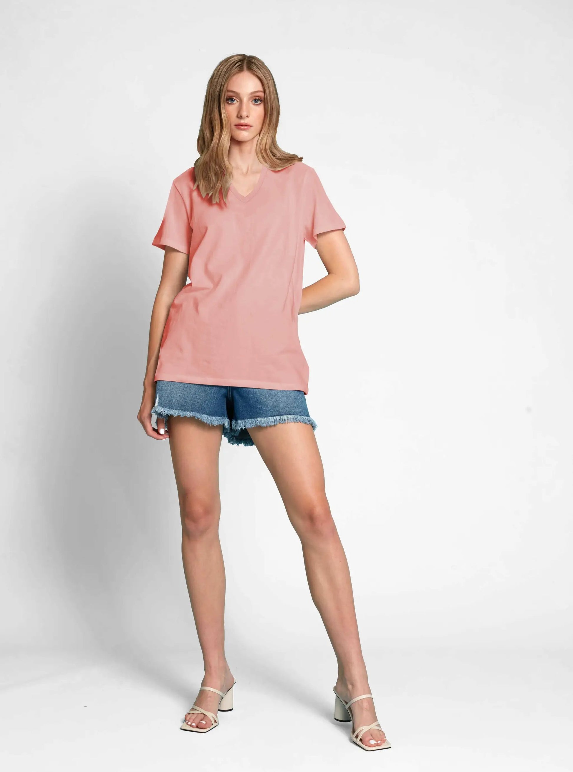 Woman posing in a high-quality, Point Zero Classic V Neck T-shirt and denim shorts against a white background.