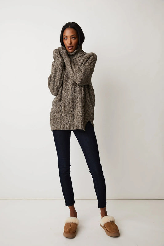 A woman wearing a Parkhurst Emily Eco Cotton Turtleneck sweater in an oversized fit.