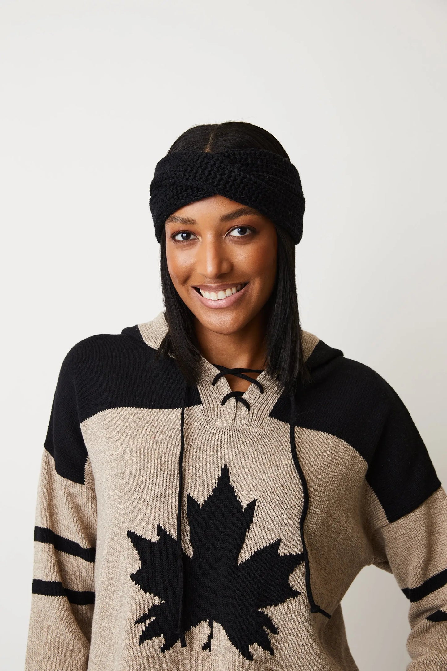 A woman wearing a high quality Cotton Country Hockey Hoodie with a Team Canada logo.