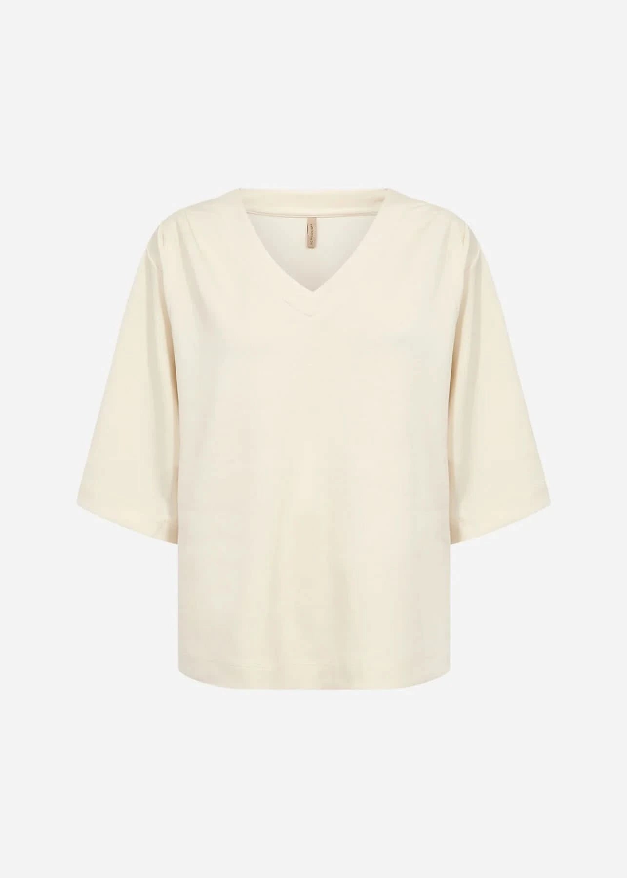 A person wearing Soya Concepts Banu Pant in cream, featuring an adjustable elastic drawstring waist, paired with a white top and brown pointed-toe shoes, stands against a plain background.