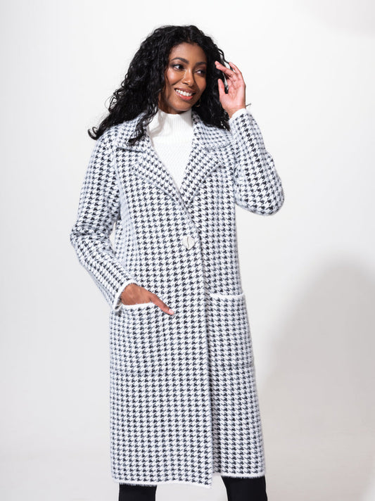 A woman wearing a cozy Alison Sheri black and white Houndstooth Cardigan.