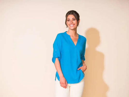 A cool woman wearing an Alison Sheri V Neckline Blouse with 3/4 Button Up Sleeve.