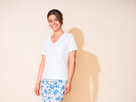 Sheri, wearing a timeless Alison Sheri Classic Premium Tee, smiling at the camera with a professional look.