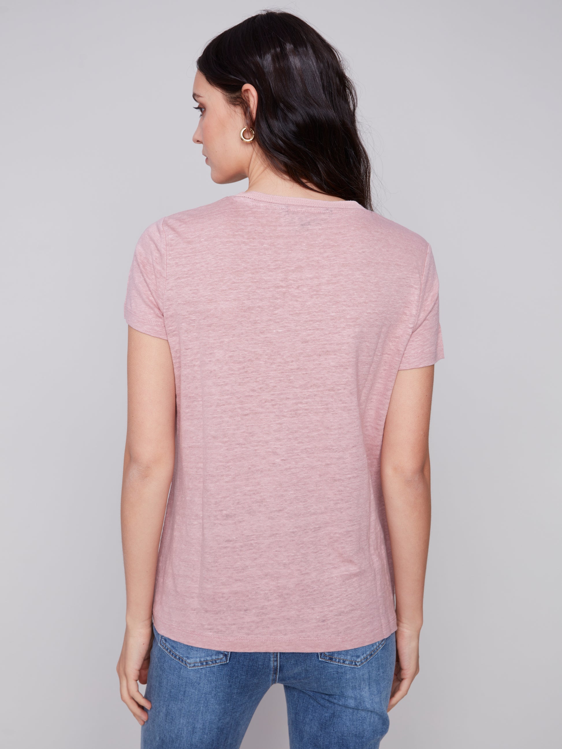 The model is wearing a pink Charlie B Linen V Neck T-Shirt, showcasing its versatility.