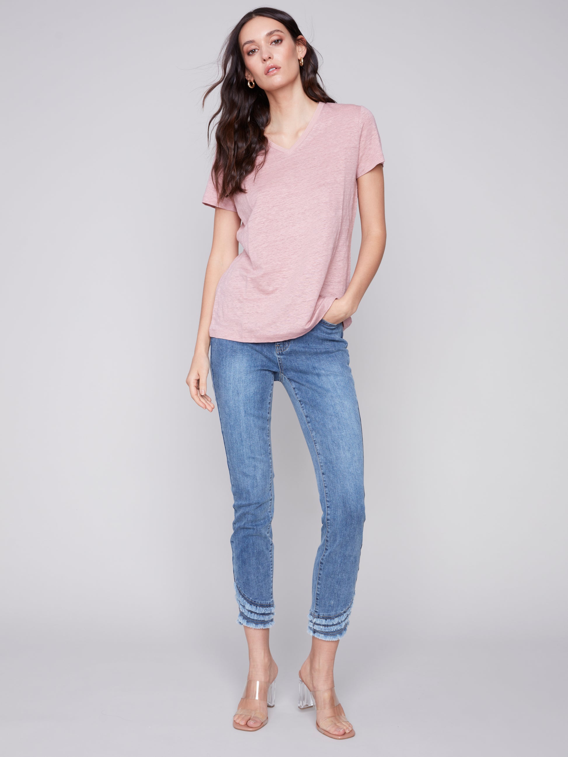The model is wearing a pink Charlie B Linen V Neck T-Shirt, showcasing its versatility.