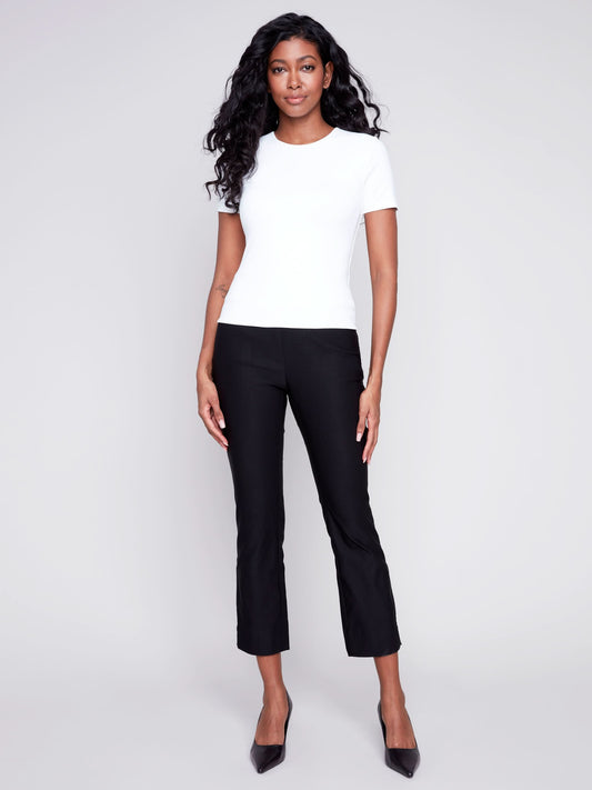 The woman is dressed in a comfortable Super Stretch Top made from a high-quality stretch fabric by Charlie B.