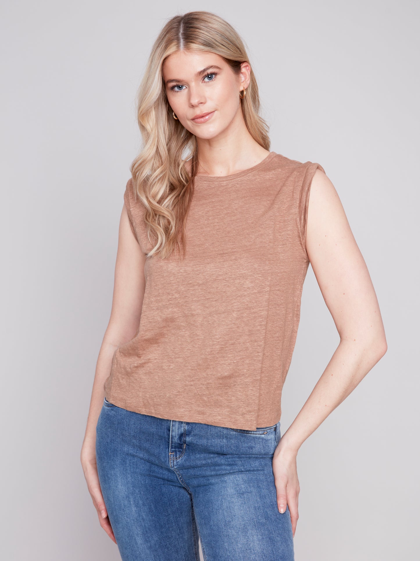 The model is wearing a Caramel Sleeveless Linen Tank by Charlie B and jeans.
