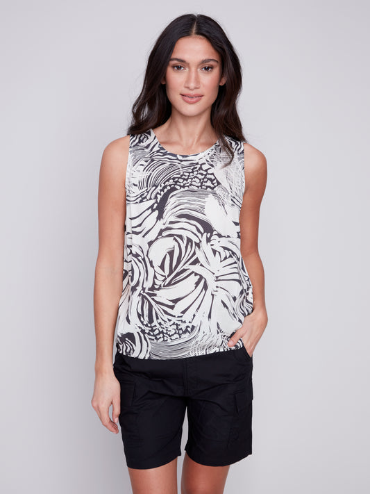A woman in trendy black and white shorts and a Classic Sleeveless Top by Charlie B.