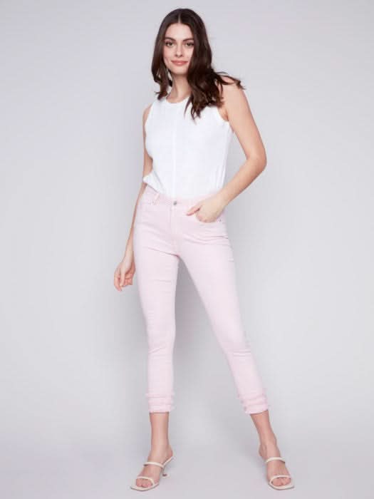Woman wearing Charlie B's Denim Fringe Crop Pant and clear heeled sandals, a trendy addition to her summer wardrobe.