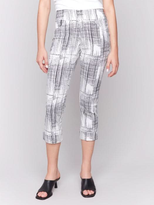 A person is wearing Charlie B's Printed Stretch Pull-On Capri Pants in black and white, offering a flattering fit. Paired with a white top and black open-toed heels, they stand against a plain background, exuding ultimate comfort for any occasion.