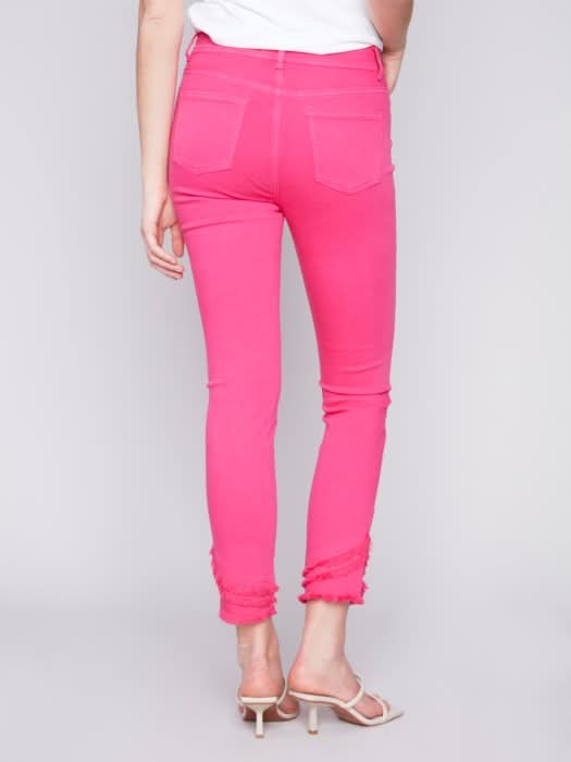 The model is wearing a cute and stylish design, combining a white t-shirt with Charlie B's Slant Fringe Ankle Pant.