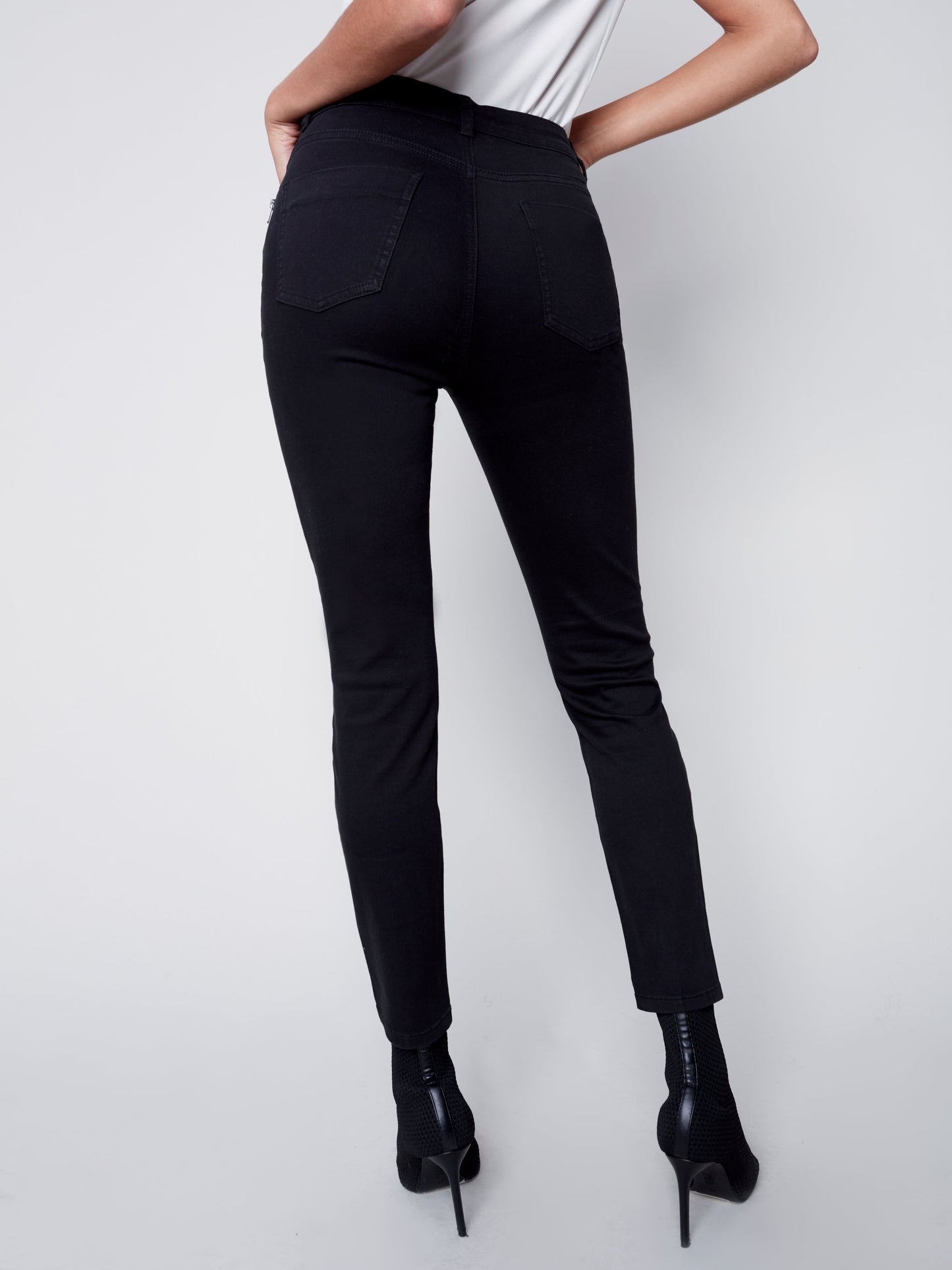 A woman wearing comfortable Charlie B Side Zip Pocket Skinny Jeans.