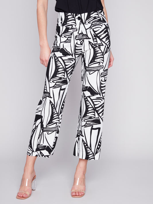 A woman wearing Charlie B's Patch Pocket Cropped Blended Linen Pant with a black and white print.
