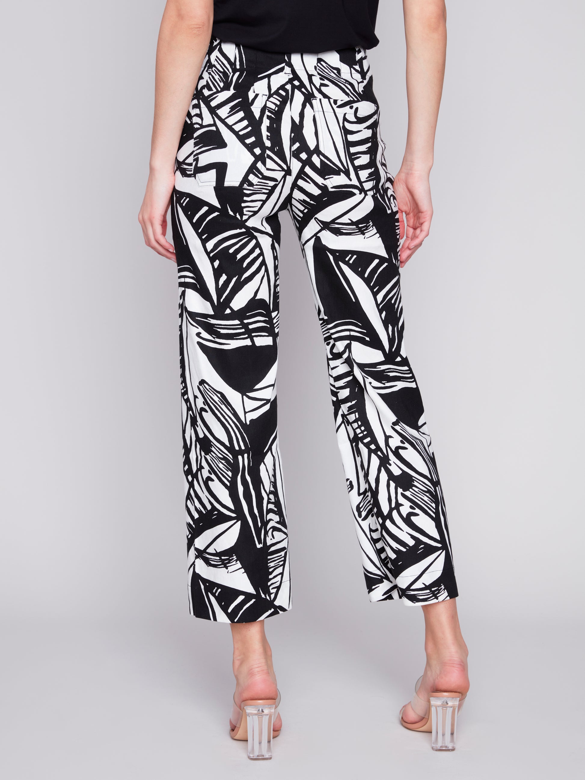 A woman wearing Charlie B's Patch Pocket Cropped Blended Linen Pant with a black and white print.